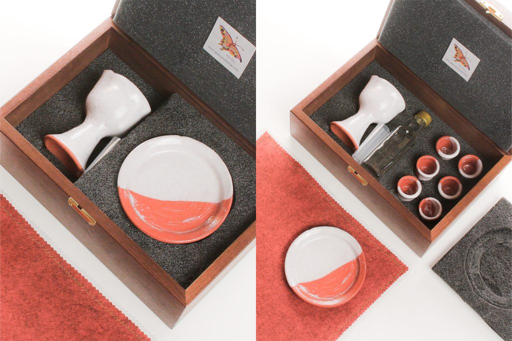 Walnut box (made in USA), custom made to fit the set, with hard foam on the inside bottom of the box, which is carved to hold the set. Soft foam lines the lid and supports the plate to cushion the ceramics for travel.