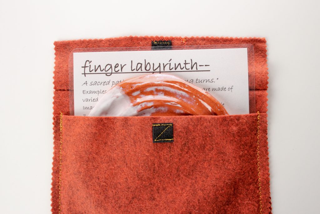 The finger labyrinth set includes a 'meaning of labyrinths' and instruction sheet and handmade cloth bag.
