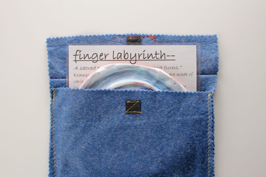 The finger labyrinth set includes a 'meaning of labyrinths' and instruction sheet and handmade cloth bag.